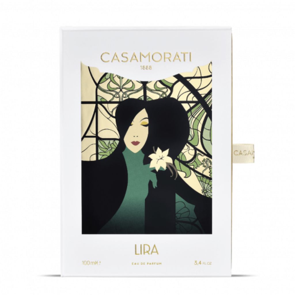A box for Casamorati 1888 Lira Eau de Parfum by XERJOFF, an oriental vanilla scent, features an Art Nouveau woman with dark hair holding a white flower before a stained glass-style background.