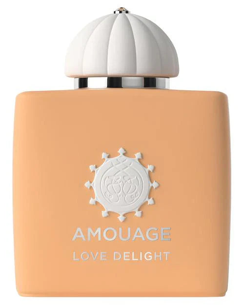 A peach-colored Love Delight Eau de Parfum bottle by Fragrapedia Haus features a white dome-shaped cap, silver accents, and the text AMOUAGE LOVE DELIGHT—a perfect choice for fans of gourmand fragrances.