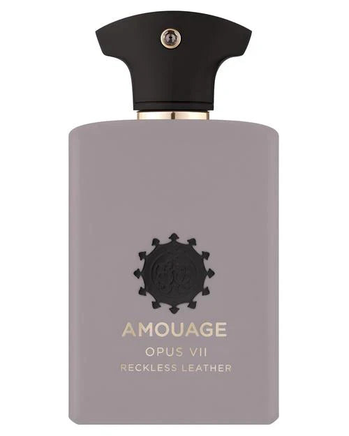 A bottle of Fragrapedia Haus Opus VII Reckless Leather Eau de Parfum, a green woody leather scent, has a matte light mauve body, black cap with silver accent, and gold lettering plus a black emblem on the front.