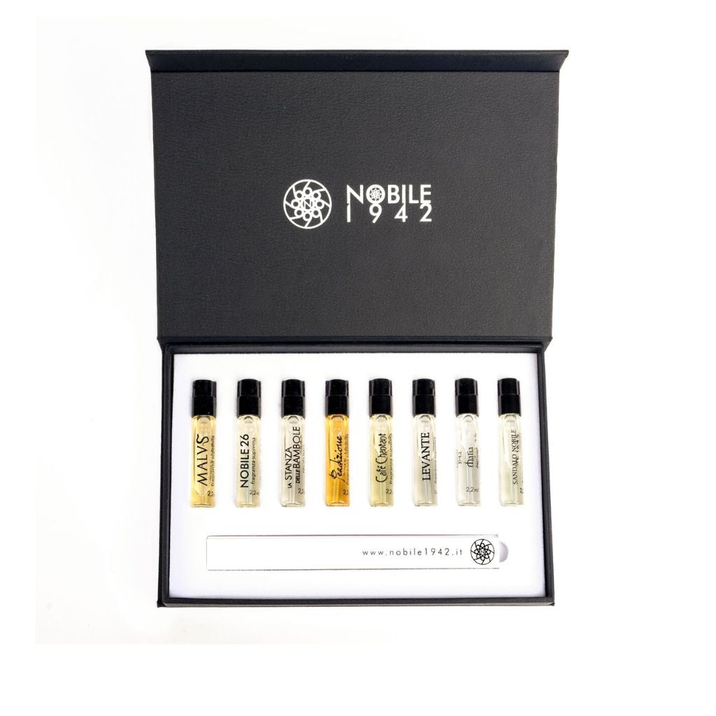 An open DISCOVERY SET - Nobile 1942 box displays eight small perfume vials and a white fragrance testing strip inside the lid. The Nobile 1942 website, www.nobile1942.it, is printed on the interior.