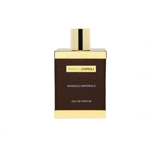 A rectangular perfume bottle with a gold cap and brown leather-textured body, labeled ANGELO CAROLI Sandalo Imperiale Eau de Parfum—a luxurious unisex scent with musk and amber notes.