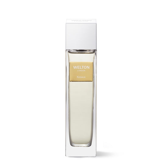 A rectangular glass bottle of Keemun EDP by Welton, filled with light liquid and a gold label, stands upright in a white luxury collection box.