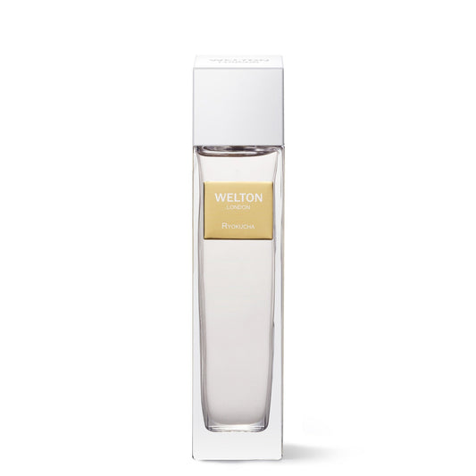 A clear glass bottle labeled Welton Ryokucha EDP with a gold label stands in a tall white box, set against a plain white background—an elegant green tea perfume from Welton in luxurious packaging.
