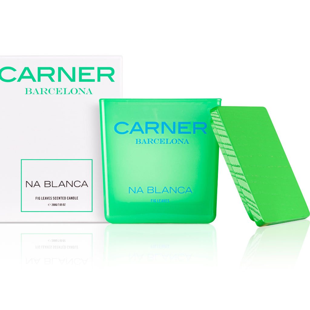 A bright green NA BLANCA CANDLE by GIFTS, inspired by Formentera and fig tree leaves scented, sits next to its matching lid and white box.