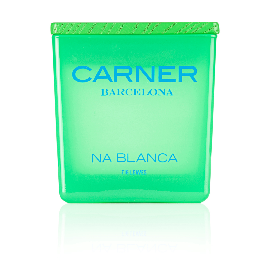 A vibrant green NA BLANCA CANDLE by Carner Barcelona for GIFTS, featuring "Fig Leaves" at the base, a textured cap, and a reflective surface beneath—evoking the fresh scent of a fig tree.