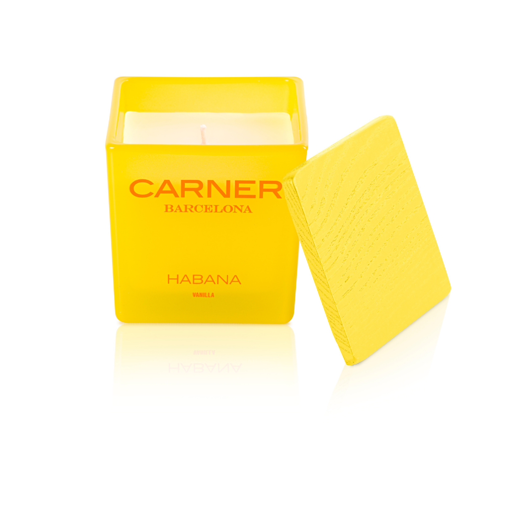 A yellow HABANA CANDLE by GIFTS (Carner Barcelona) sits in a square glass container with a matching yellow lid nearby, set against a white background.