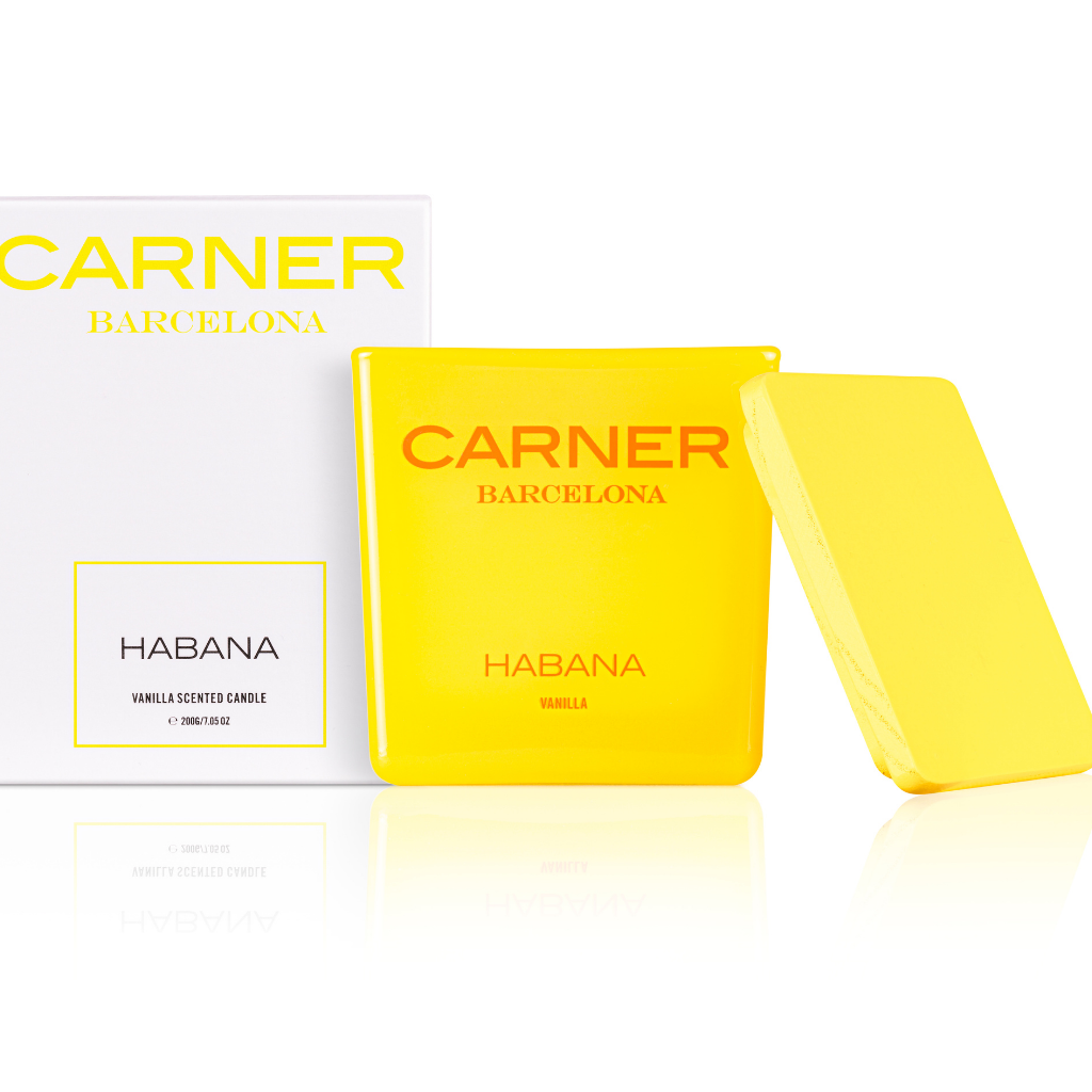 A vibrant yellow GIFTS HABANA CANDLE by Carner Barcelona with a matching lid sits beside its white box labeled "HABANA VANILLA SCENTED CANDLE.