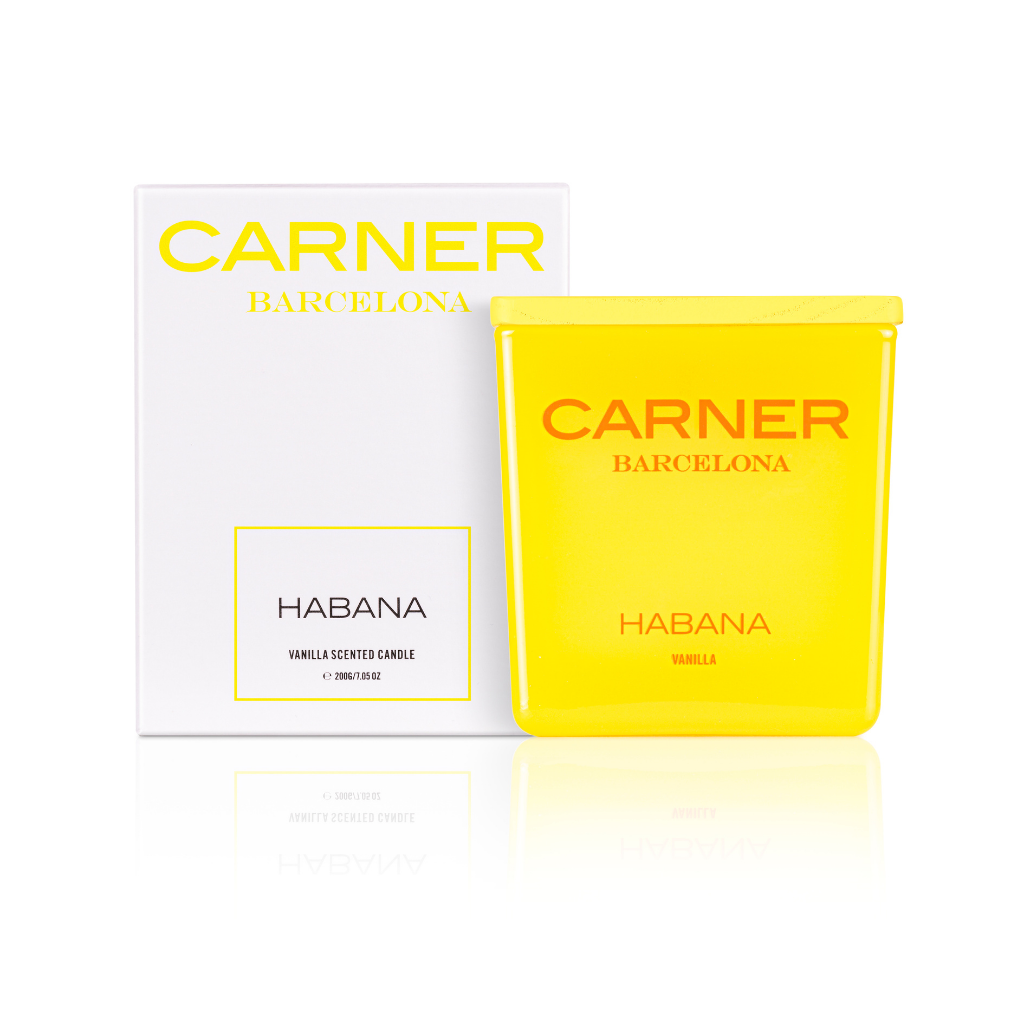 A bright yellow HABANA CANDLE by Carner Barcelona from GIFTS stands before a matching white and yellow box, both featuring the branding and highlighting its vanilla scent.