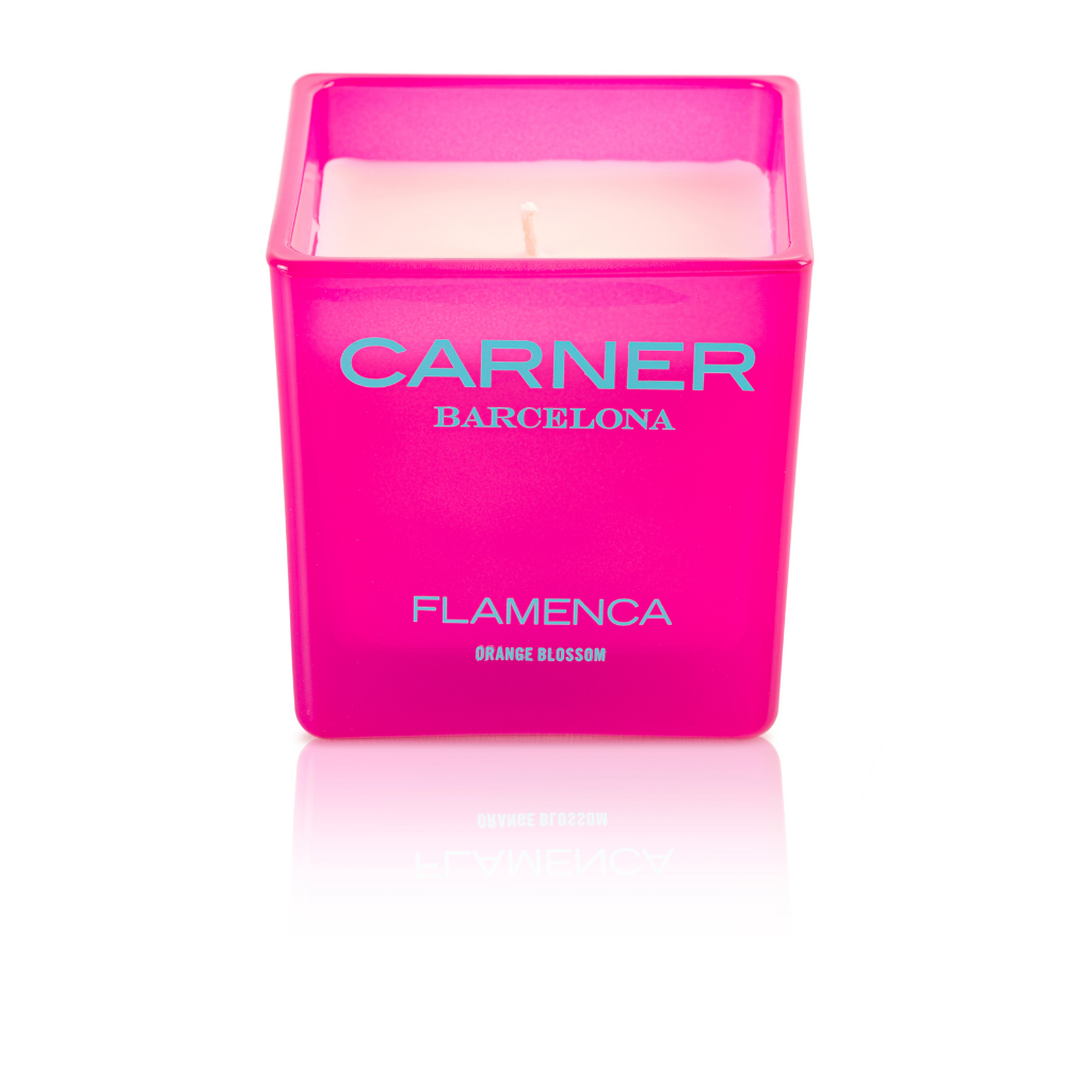 The FLAMENCA CANDLE - Carner Barcelona by GIFTS is a pink square candle with white wax, labeled in silver and white, featuring uplifting bergamot notes for a fresh aroma.