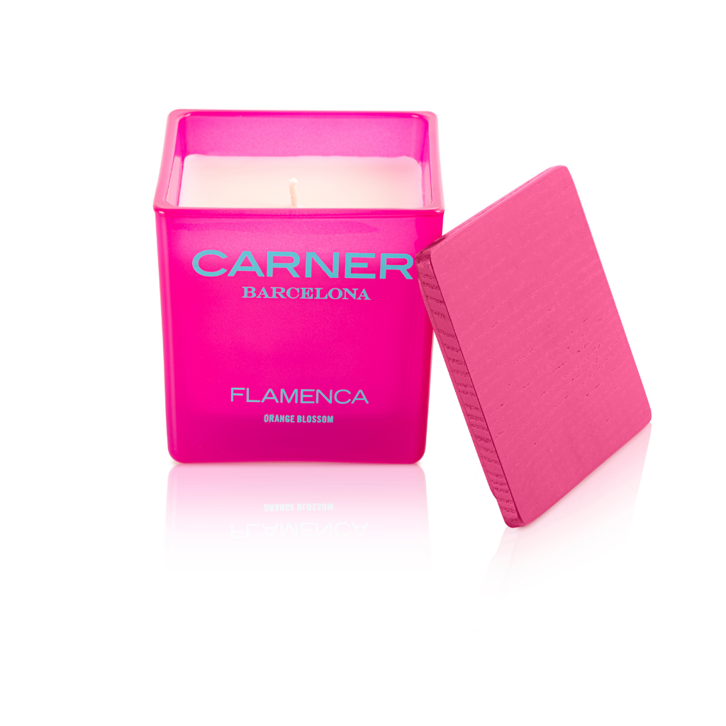 A pink FLAMENCA CANDLE by GIFTS from Carner Barcelona, featuring a matching pink lid and notes of bergamot, set against a white background.