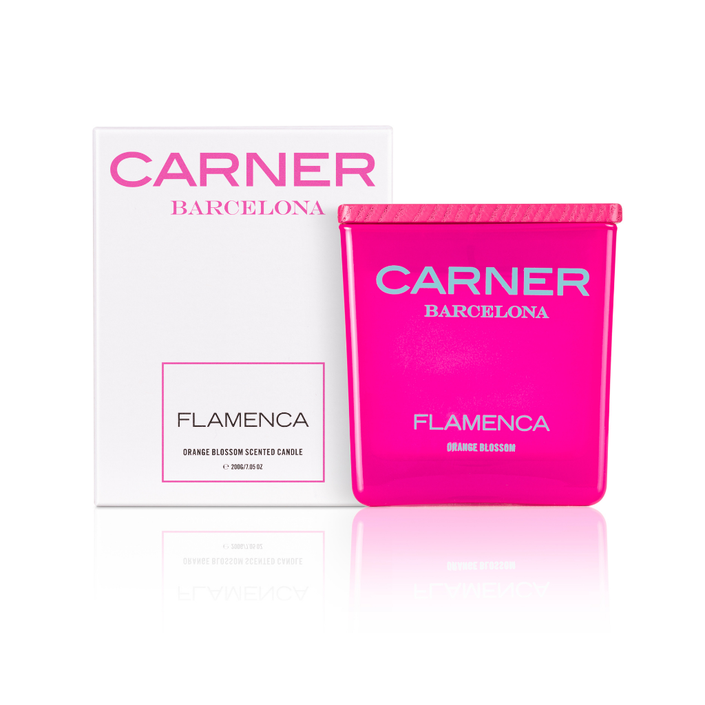 A vibrant pink FLAMENCA CANDLE by GIFTS, scented with orange blossom and bergamot, is displayed before its white box packaging, both featuring bold pink branding and product information.