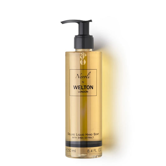 A clear plastic pump bottle of Welton London NEROLI DELUXE LIQUID HAND SOAP WITH SHEA EXTRACT, containing 250 ml (8.4 fl oz) of golden-yellow soap, is photographed against a white background.