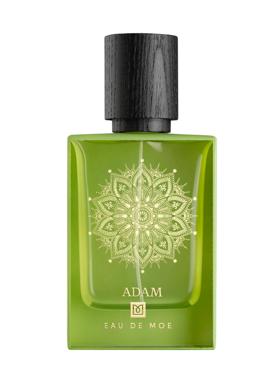 A green ADAM Eau de Parfum bottle by Eau De Moe features a black cap and intricate gold mandala, embodying a men's fragrance with notes of Italian bergamot.