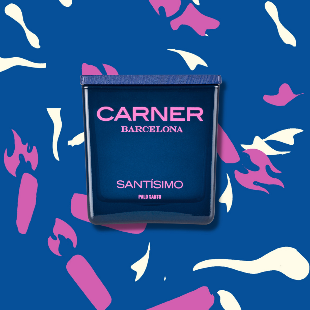 A blue SANTÍSIMO CANDLE by Carner sits against a blue backdrop with abstract pink and white shapes resembling flames and candles, evoking musky and guaiac wood notes.