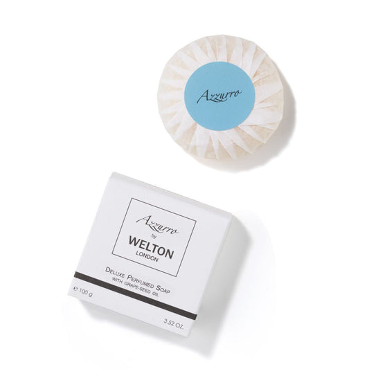 A round, wrapped AZZURRO DELUXE PERFUMED SOAP WITH GRAPE-SEED OIL by Welton London sits beside its white box on a white background. The box notes it’s made in France and weighs 3.52 oz.