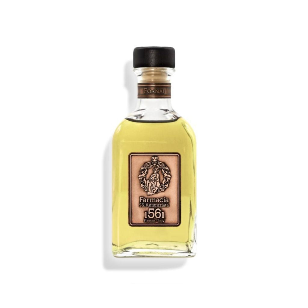 The Fornai DIFFUSER by Farmacia SS. Annunziata 1561 features a clear glass bottle with light yellow liquid, black cap, and a beige label with an ornate crest—perfect as a cinnamon vanilla home fragrance diffuser. Shown on a white background.