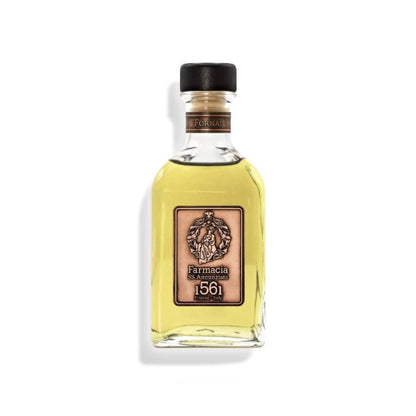 The Fornai DIFFUSER by Farmacia SS. Annunziata 1561 features a clear glass bottle with light yellow liquid, black cap, and a beige label with an ornate crest—perfect as a cinnamon vanilla home fragrance diffuser. Shown on a white background.