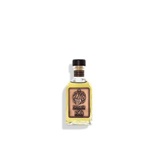 The Fornai DIFFUSER - Farmacia by Farmacia SS. Annunziata 1561 is a small glass bottle of yellow liquid with a black cap and tan label, featuring an ornate emblem and text, displayed elegantly on a white background.