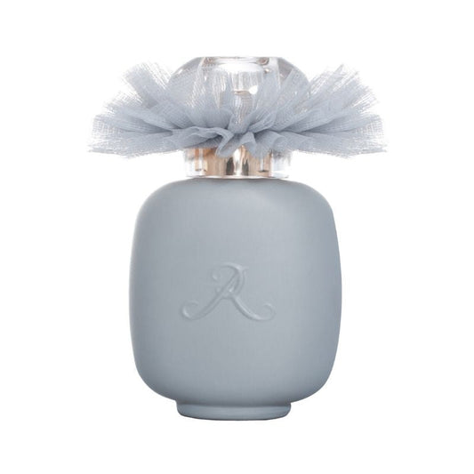 A matte light grey BALLERINA N°2 Eau de Parfum bottle by LES PARFUMS DE ROSINE with a translucent cap, sheer grey tulle bow, and embossed "R," hinting at the woody floral scent inside.
