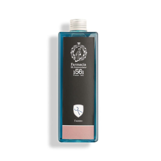 A rectangular diffuser refill bottle with blue liquid, silver cap, and a front label reading "Farmacia SS. Annunziata 1561 Firenze, Italy" with crest and "Fabbri"—perfect for enhancing your home fragrance experience.