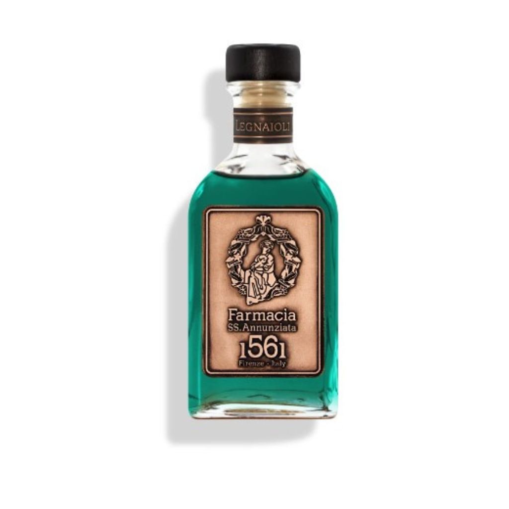 The Legnaioli DIFFUSER by Farmacia SS. Annunziata 1561 features teal liquid in a clear glass bottle with a black cap, tan label, and sleek black sticks to diffuse its wooden fragrance.