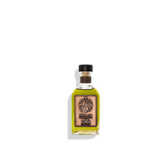 A small glass Oliandoli e Pizzicagnoli DIFFUSER by Farmacia SS. Annunziata 1561, filled with yellow-green liquid and topped with a black cap and tan label featuring the Farmacia 1561 emblem, set against a white background.