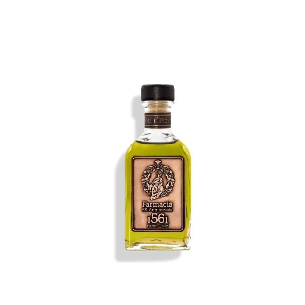 The Farmacia SS. Annunziata 1561 Oliandoli e Pizzicagnoli DIFFUSER features a clear glass bottle with yellow-green oil, black cap, and vintage label—an elegant way to diffuse rosemary lavender scent in your space.
