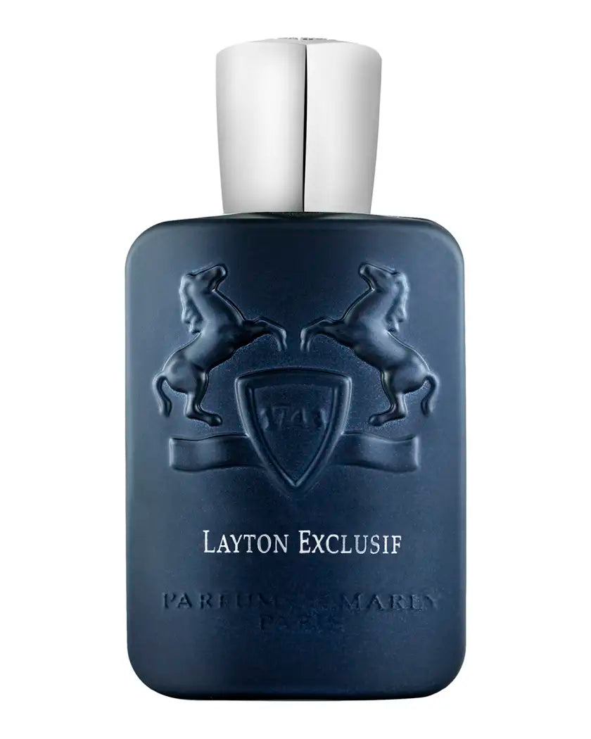 The Layton Exclusive Eau de Parfum by Parfums de Marly comes in a dark blue bottle with embossed rearing horses and silver cap, featuring the brand’s crest and offering a distinctly luxurious fragrance experience.