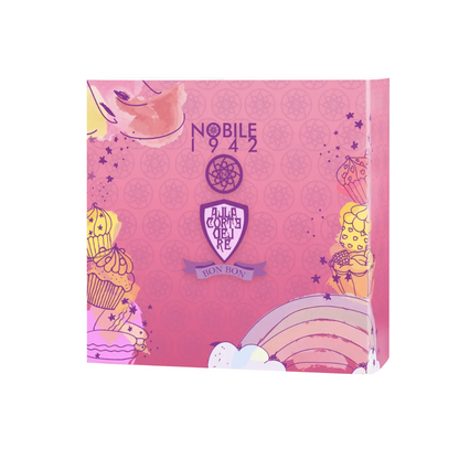 The BON BON - Nobile 1942 by Nobile 1942 comes in a pink, square box adorned with cupcake and rainbow illustrations, playful colors, and a central purple emblem—a fairy tale-inspired fragrance with sweet notes.