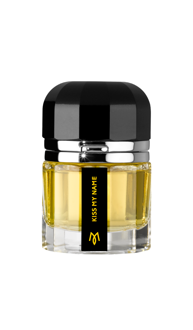 A glass bottle of yellow liquid with a black and silver cap, Kiss My Name Eau de Parfum by Ramon Monegal is an elegant tuberose fragrance featuring a gold logo beneath the label.