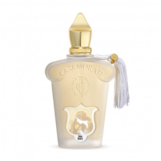 A white and gold XERJOFF Casamorati 1888 Dama Bianca Eau de Parfum bottle features a gold cap, ornate crest, white tassel, and base silhouette, reflecting its floral woody musk scent.