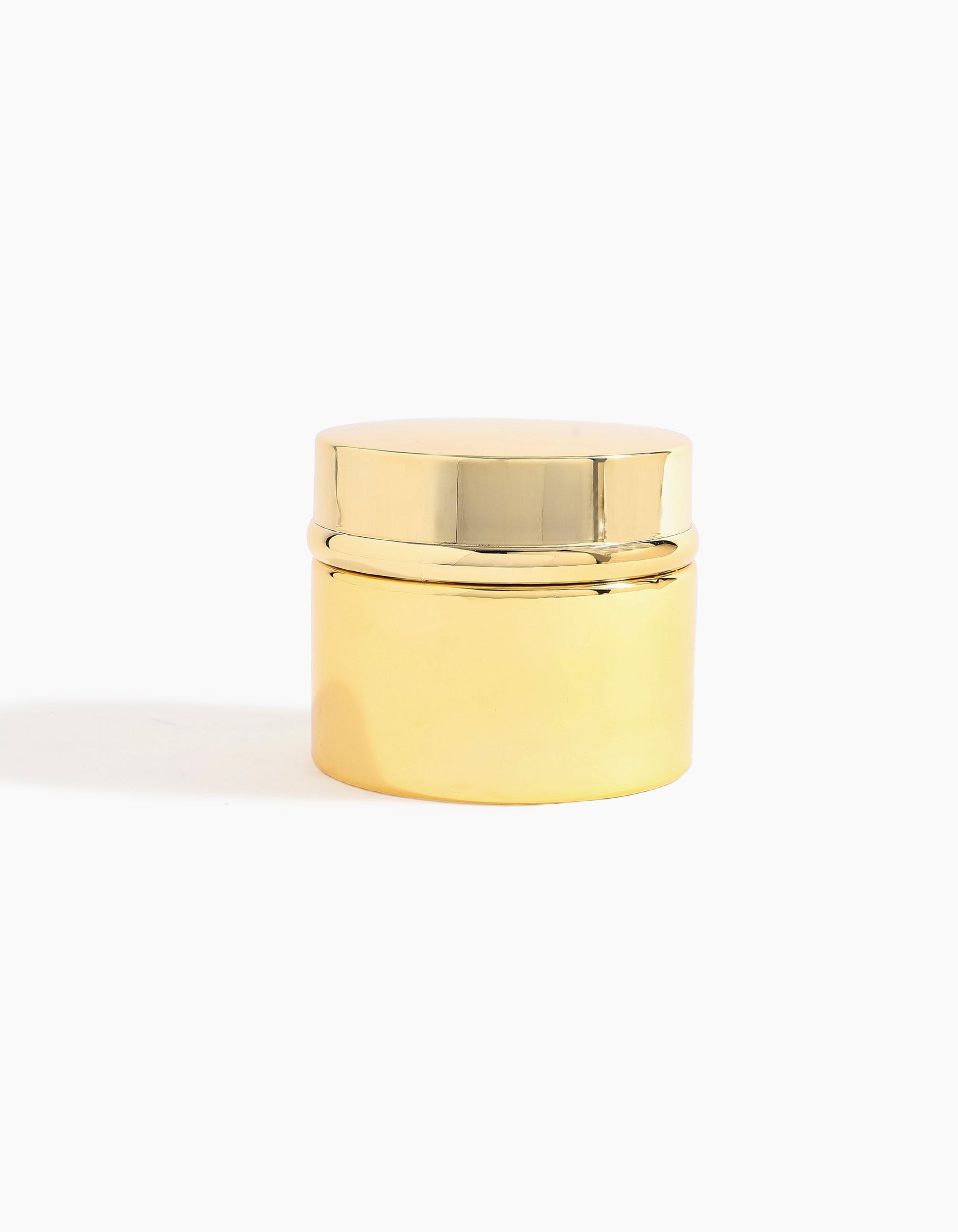 A small, shiny gold-toned cylindrical container with a matching lid, capturing the luxurious essence of Al Shioukh Dokhoon - Hind Al Oud by Hind Al Oud, set against a plain white background.