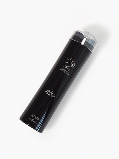 A tall, black cylindrical body lotion bottle labeled Hind Al Oud Barari with white Arabic and English text, a silver cap, and a minimalist deer logo evokes the essence of Barari Body Lotion, photographed on a white background.