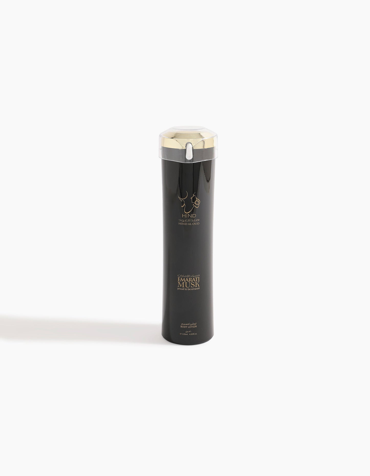 A tall, sleek black bottle with a silver cap and gold accents, featuring the logo and text Emarati Musk Body Lotion and Hind Al Oud on the front, evokes the luxurious allure of musk, standing upright against a plain white background.