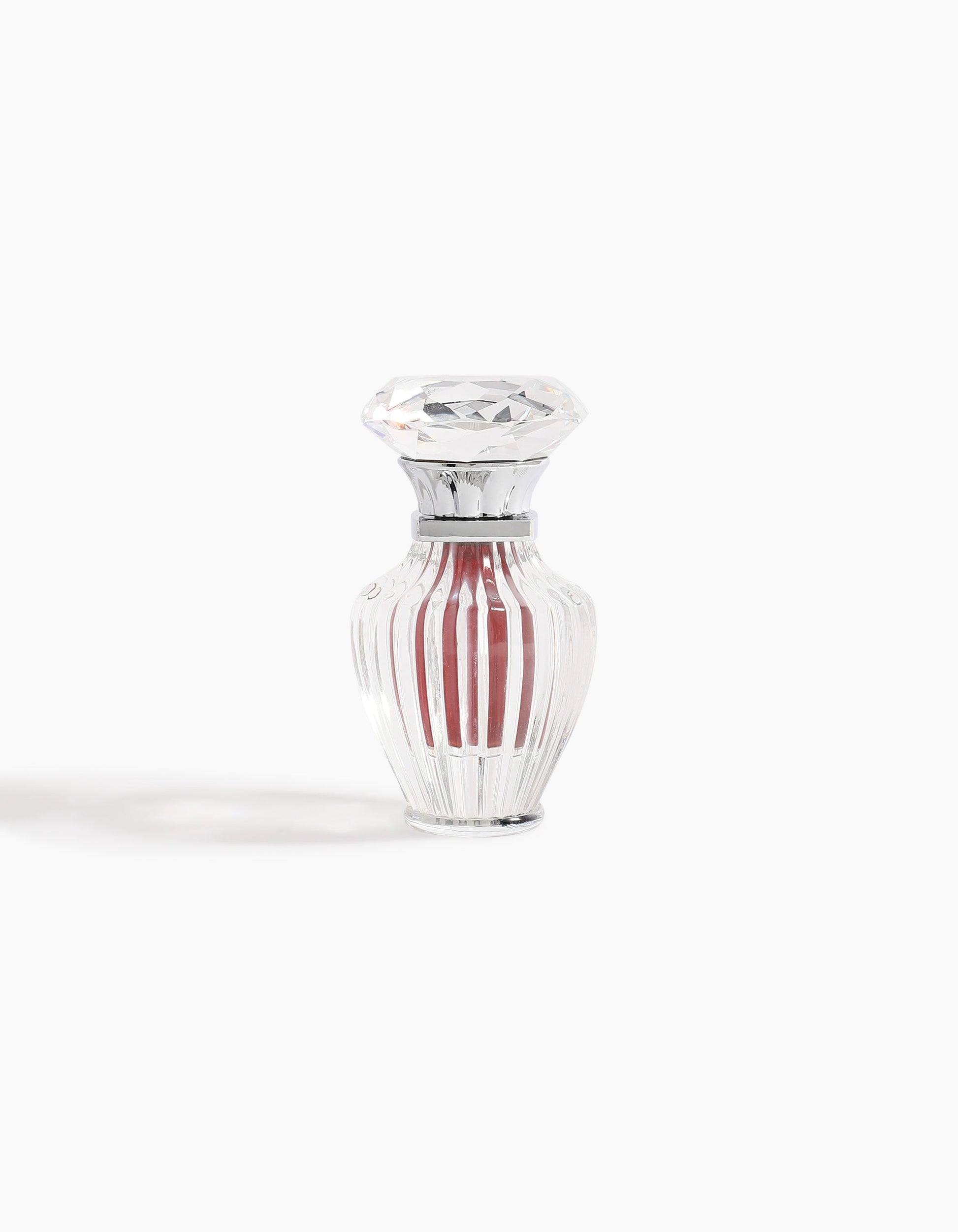 A clear, faceted glass bottle with a diamond-shaped stopper contains 6ml of Hind Al Oud's Hindi Malaki Pure Dehn Oud Concentrated Oil, displayed against a plain white background.