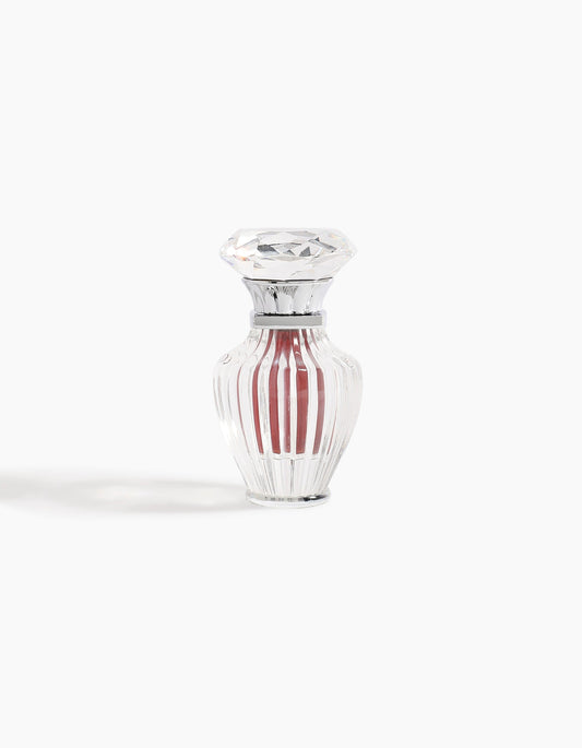 A clear, faceted glass bottle with a diamond-shaped stopper contains 6ml of Hind Al Oud's Hindi Malaki Pure Dehn Oud Concentrated Oil, displayed against a plain white background.