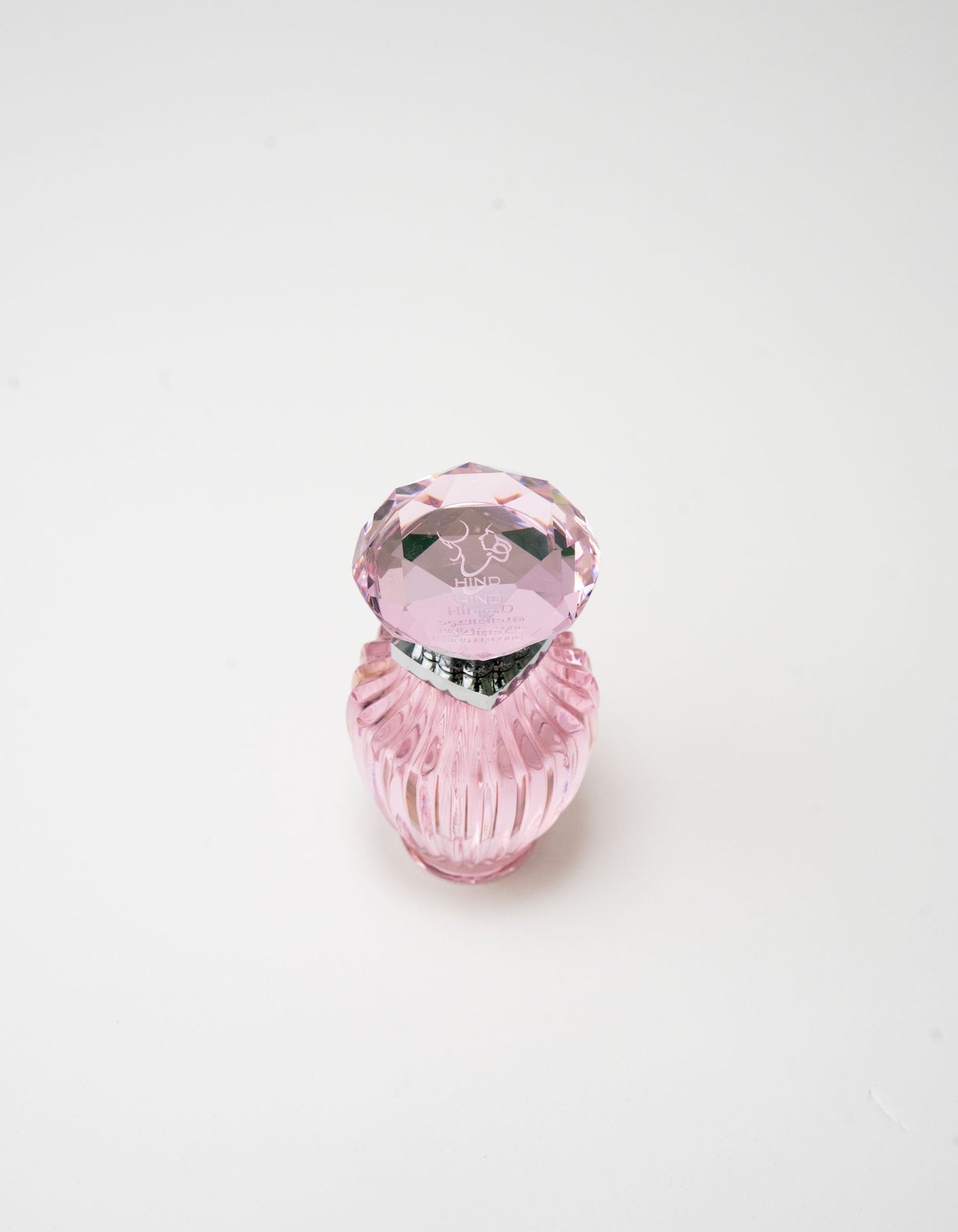 The Hind Al Oud Pink Oud Concentrated Oil 6ml is presented in a small, elegant pink bottle with a faceted cap, featuring jasmine notes and displayed on a simple white background.