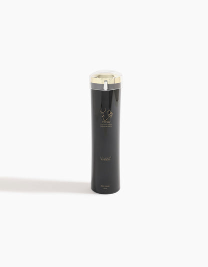 A sleek black bottle with a gold cap and minimalist gold design stands on a white background. Labeled Hind Al Oud and Ahojas Body Lotion, this product hints at notes of fig and tobacco for a luxurious skincare experience.