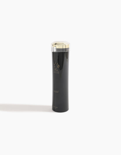 Ahojas Body Lotion by Hind Al Oud stands tall in a sleek black bottle with a silver and gold cap, featuring gold accents on its design—hinting at the luxurious fig and tobacco notes inside.