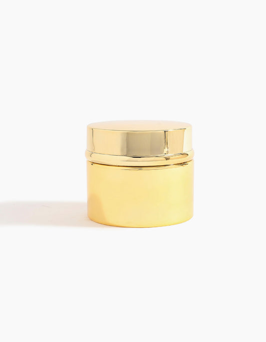 A small, round, shiny gold container with a matching lid holds Hind Al Oud Hind Dokhoon by Hind Al Oud, showcased against a plain white background.