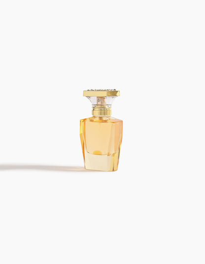 Ahojas Hair Mist by Hind Al Oud is showcased in a faceted glass bottle with golden-yellow liquid and a gold rectangular cap, centered on a white background to highlight the product’s elegance.