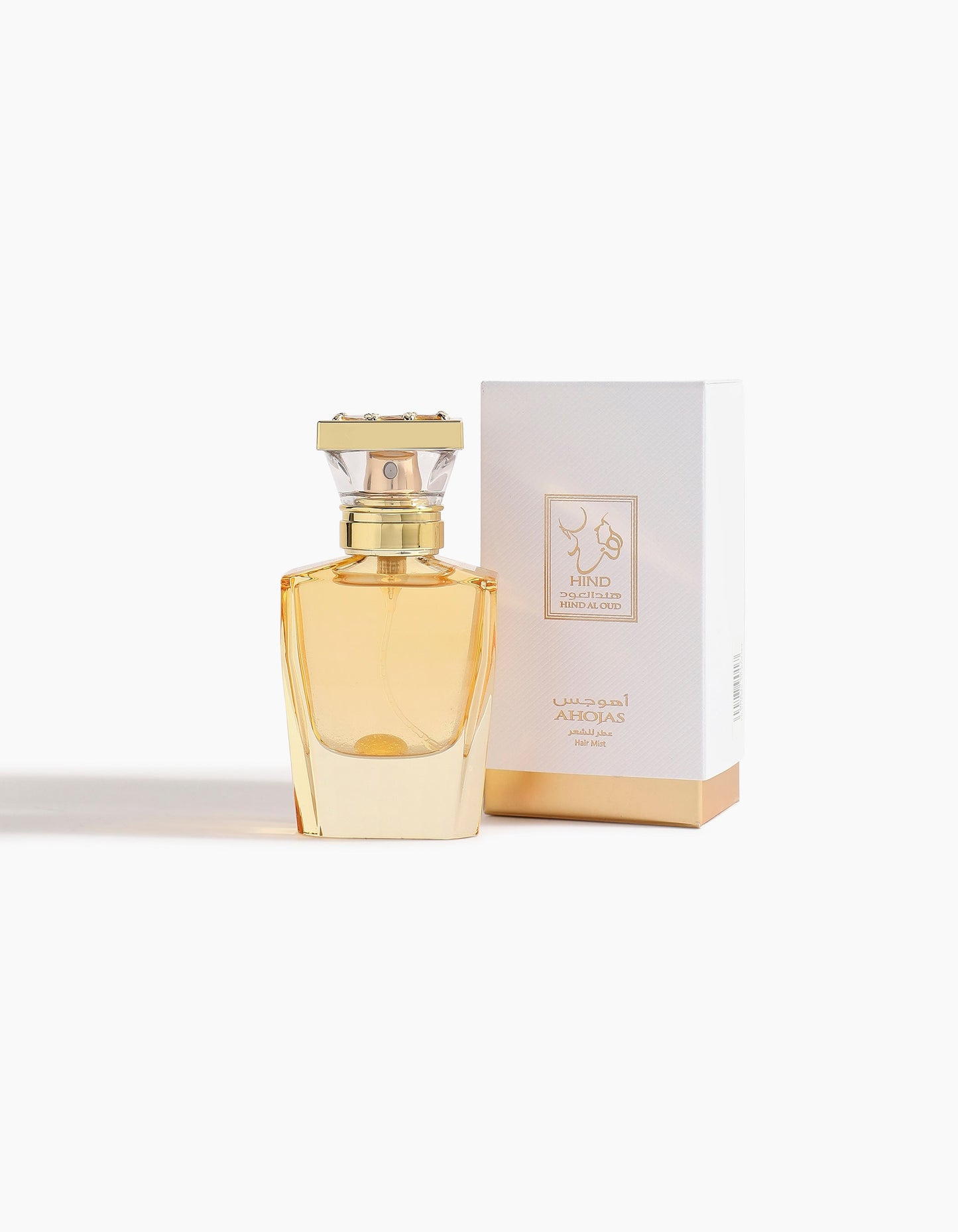 Ahojas Hair Mist by Hind Al Oud, in a gold bottle with a rectangular cap, is displayed before a matching white and gold box labeled in English and Arabic—this release showcases a luxurious floriental scent against a white background.
