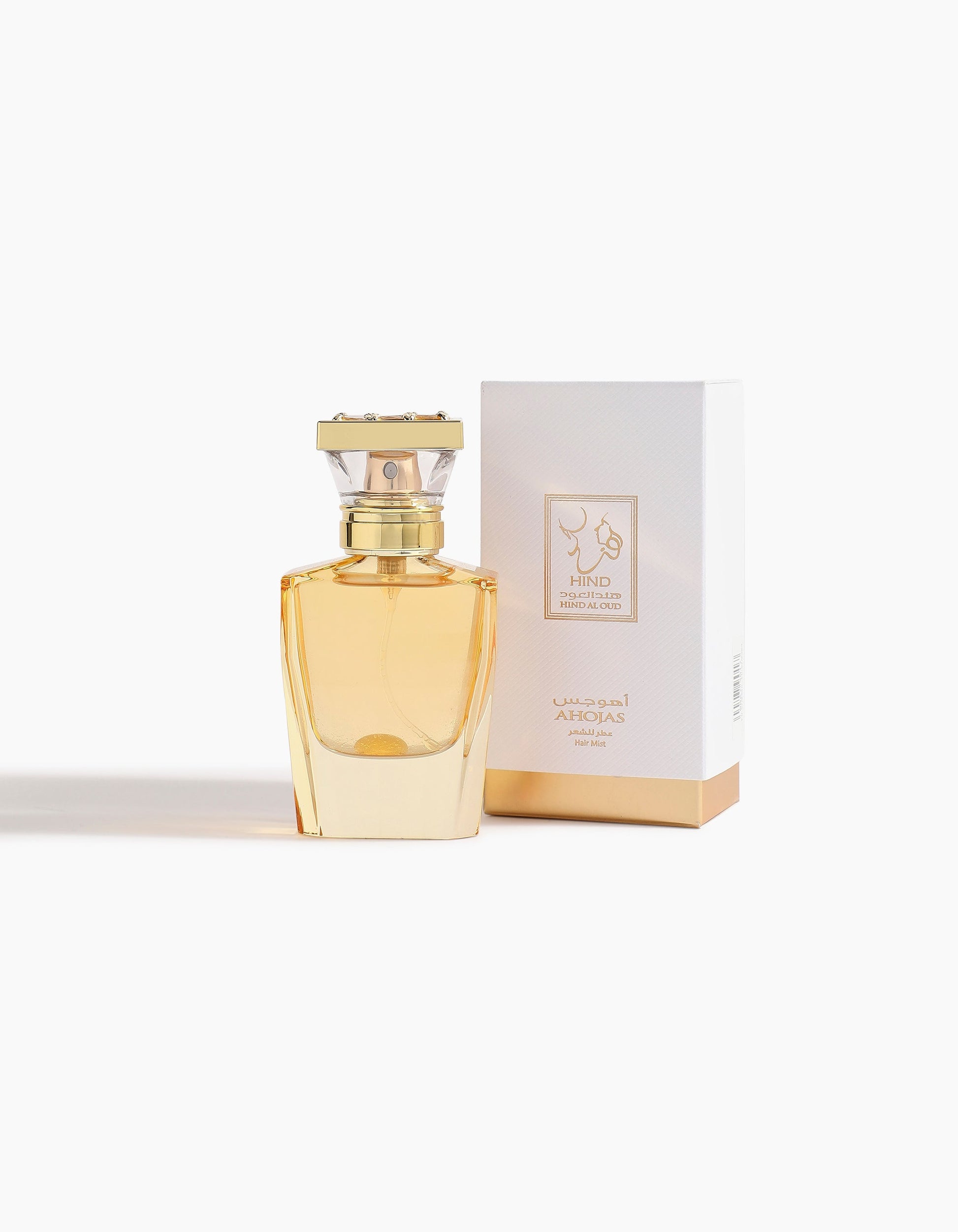Ahojas Hair Mist by Hind Al Oud, in a gold bottle with a rectangular cap, is displayed before a matching white and gold box labeled in English and Arabic—this release showcases a luxurious floriental scent against a white background.