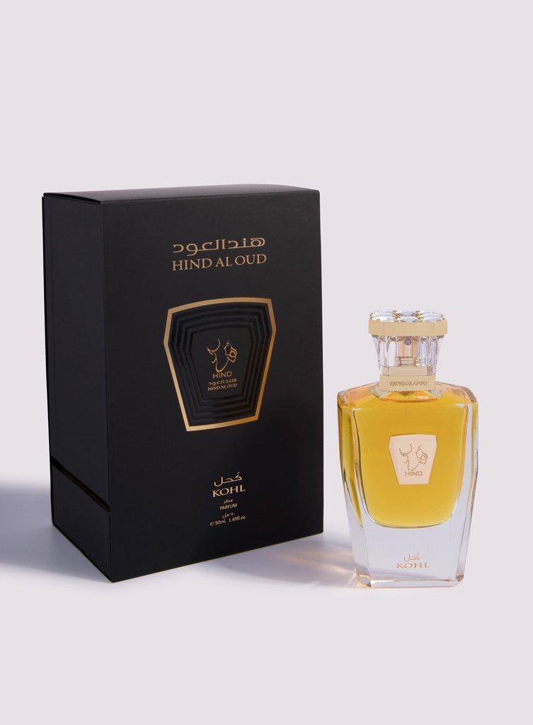 Kohl Parfum by Hind Al Oud features an amber-hued saffron and agarwood fragrance in a clear glass bottle with gold accents and cap, elegantly packaged in a branded box.