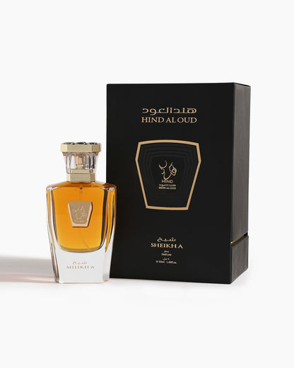 A bottle of Sheikh A Parfum by Hind Al Oud sits beside its black and gold box, highlighting the luxurious branding and elegant design inspired by opulent agarwood notes.