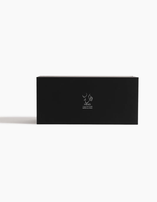 The Oud Obsession Gift Set by Hind Al Oud comes in a sleek rectangular black box with a minimalist white logo and text, making it an elegant choice for any occasion.