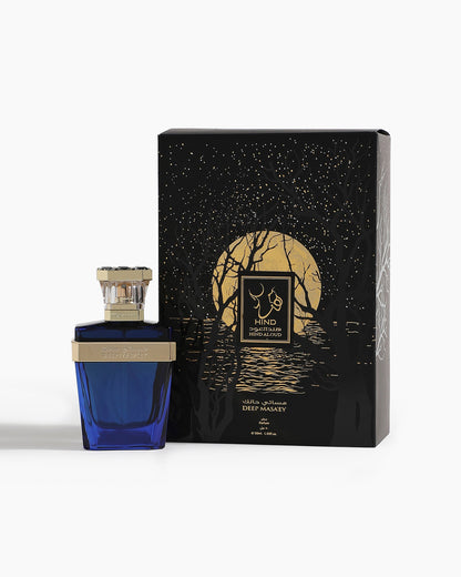 A blue Deep Masa'ey Parfum bottle by Hind Al Oud with a silver cap stands next to a black box featuring a gold moon, starry sky, and trees. The fragrance has notes of nutmeg and cashmere wood, labeled in English and Arabic.