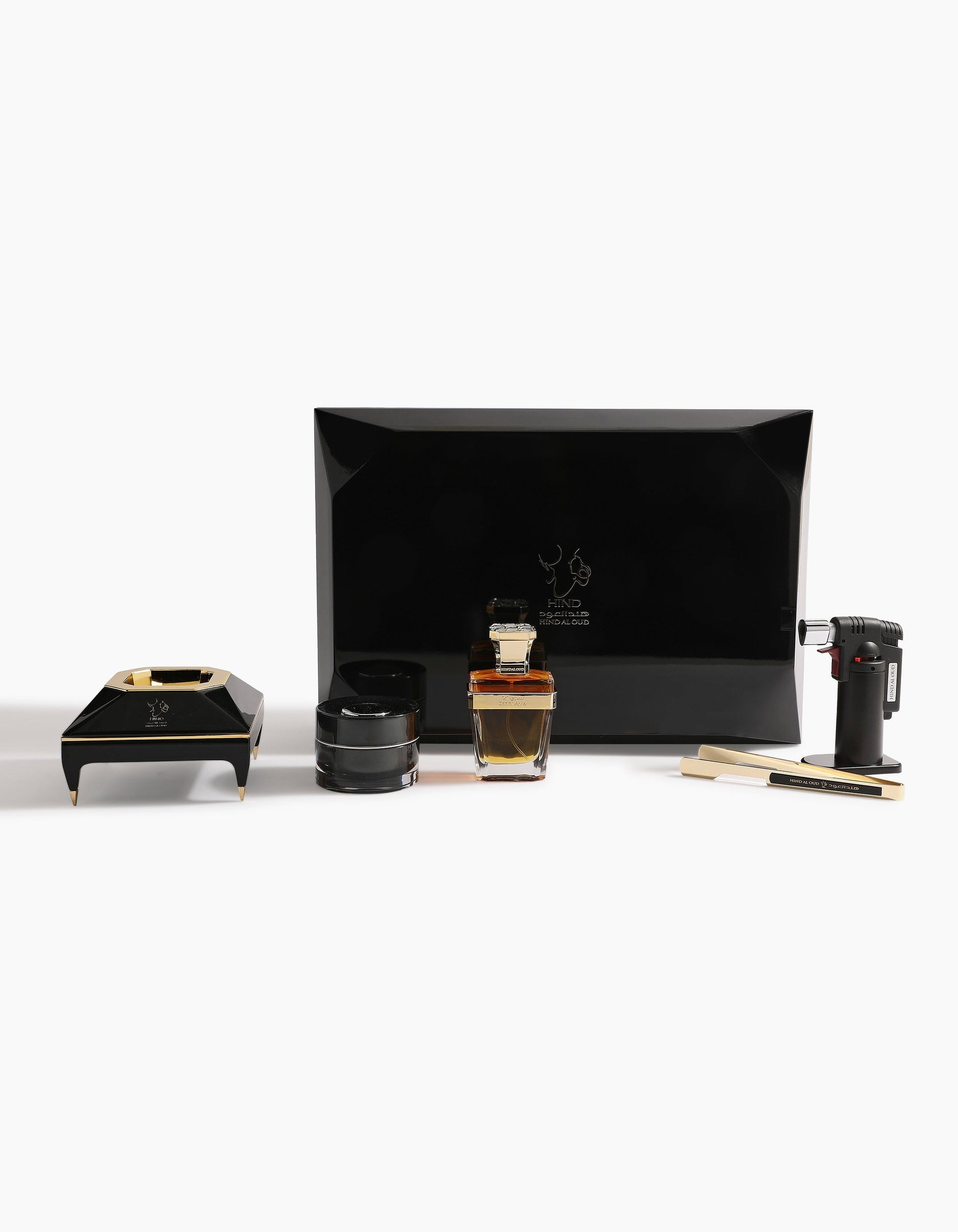 The Diamond Incense Kit Gift Box Option B by Hind Al Oud is a luxury black set with a rectangular box, ashtray, jar, torch lighter, two wooden sticks, and a gold-accented Sheikh A Oud perfume bottle displayed on white.