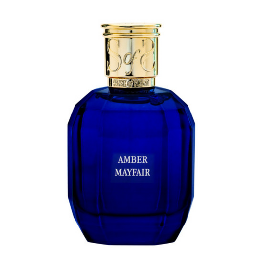 A deep blue, faceted perfume bottle with a gold cap and a label reading "AMBER MAYFAIR Eau de Parfum - Sense of Scent" in white—a signature fragrance from Sense of Scent exuding timeless elegance.