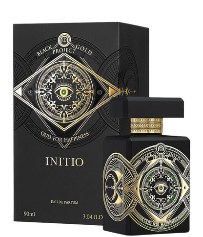 A black bottle of INITIO Oud For Happiness Eau de Parfum, detailed with gold and green eyes, is displayed before its box—a woody spicy fragrance by INITIO, 90ml.